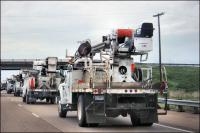 Electrical Company trucks driving southwest on Hwy 40 from Michegan, Kansas, Virginia, and Indiana to restore electricity in Louisiana and Mississippi after Hurricane Gustav