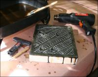 Encaustics work table: heat gun to fuse wax to surfaces, a piece I worked on yesterday, some scraping tools, and an electric frying pan melts naturally colored beeswax 