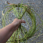 Pull out 1/4 of the vines on each side of wreath and wrap with wire. Continue wrapping groups of vines together in a symmetrical fashion.